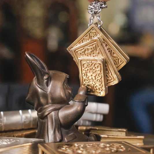 Hawthorn the Rabbit jewelry dish with the bronze Favorite Book Pile Pendants